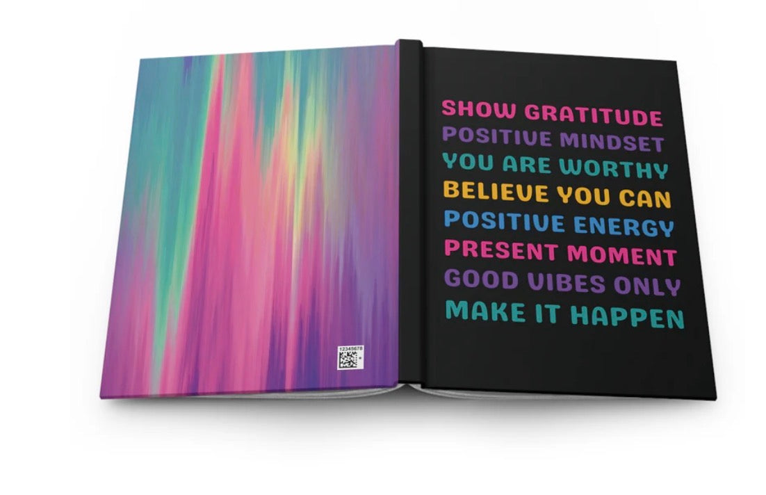An open notebook or journal on a white background, showing a colorful abstract gradient cover on the left page and a black right page with motivational text in pink, purple, yellow, and blue.