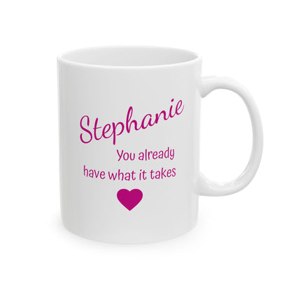 White mug with pink text and heart design on a white background