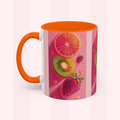 A ceramic mug with a bright orange handle and interior, decorated with a pink and white striped design featuring illustrations of sliced grapefruit, kiwi, strawberry, and raspberry.