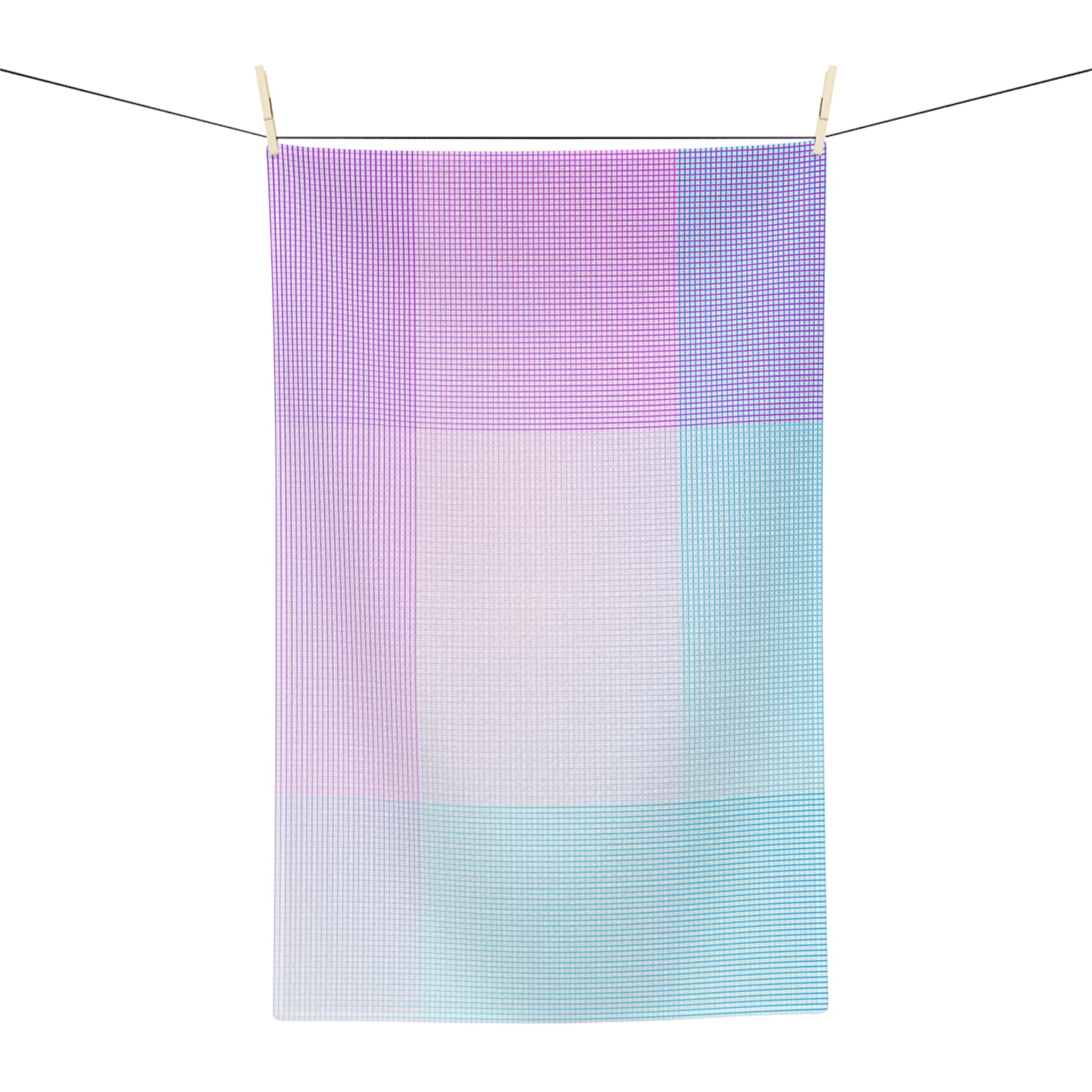 A rectangular kitchen towel with a pastel grid pattern hangs from two wooden clothespins on a wire against a plain white background.