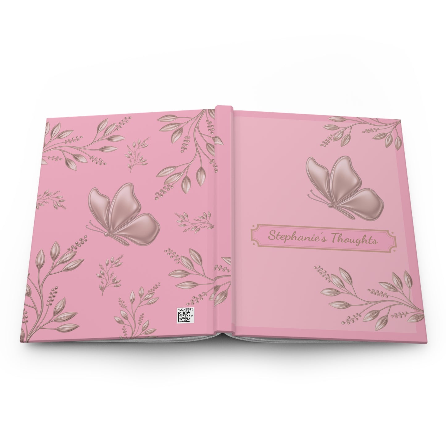 An open pink keepsake album or journal with butterfly and floral illustrations, featuring the title 'Stephanie's Thoughts' on the right page.