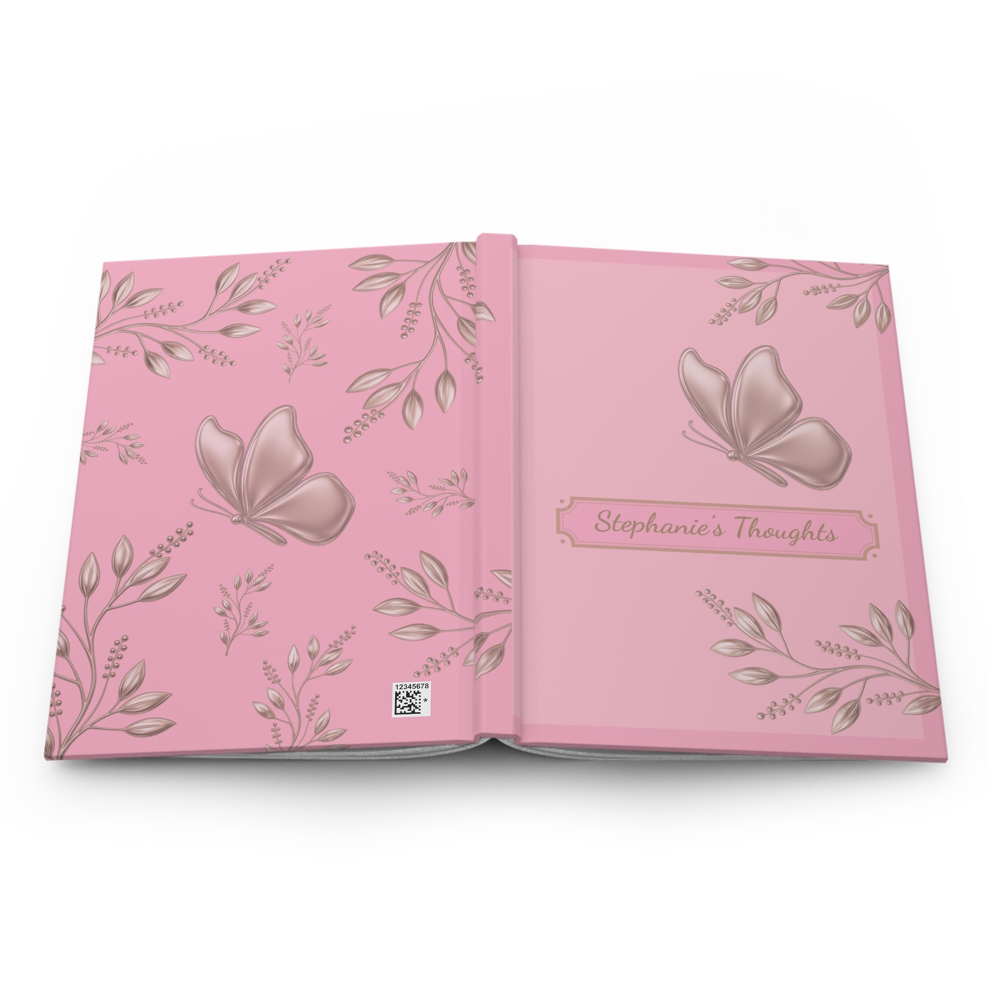 An open pink keepsake album or journal with butterfly and floral illustrations, featuring the title 'Stephanie's Thoughts' on the right page.