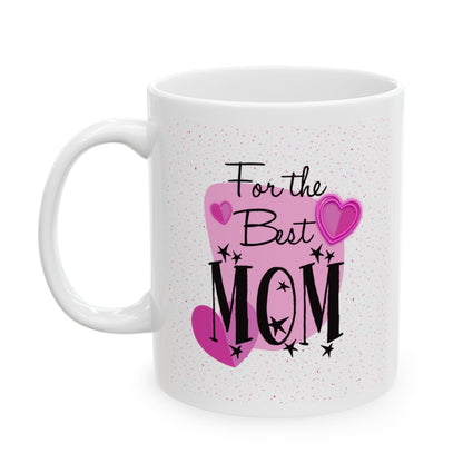 A white ceramic mug with a printed design that reads 'For the Best MOM' in black script and block lettering, decorated with pink hearts and small black star accents, on a clean white background.