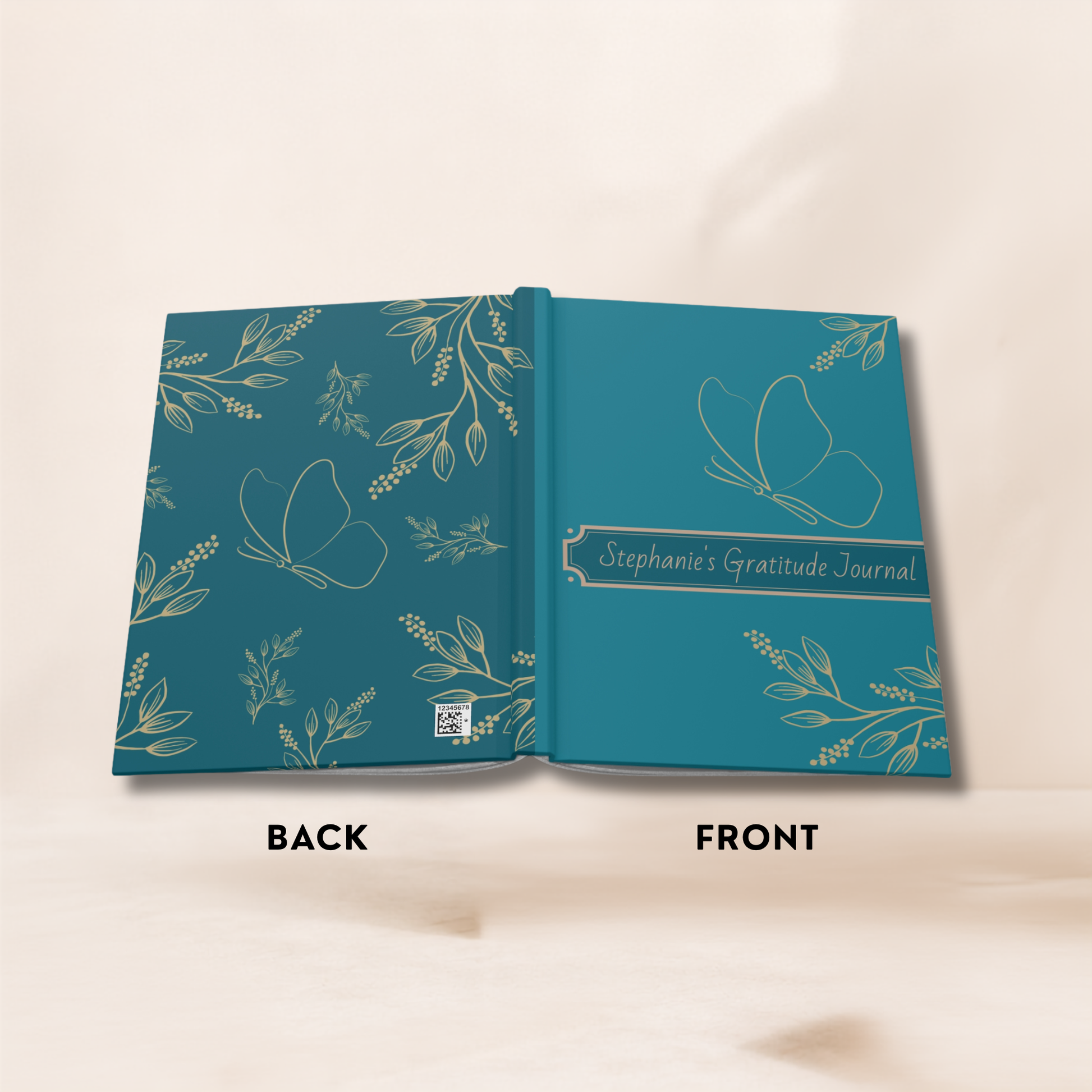 An open teal gratitude journal with botanical and butterfly illustrations, showing the front cover on the right and back cover on the left. The right page reads 'Stephanie's Gratitude Journal.