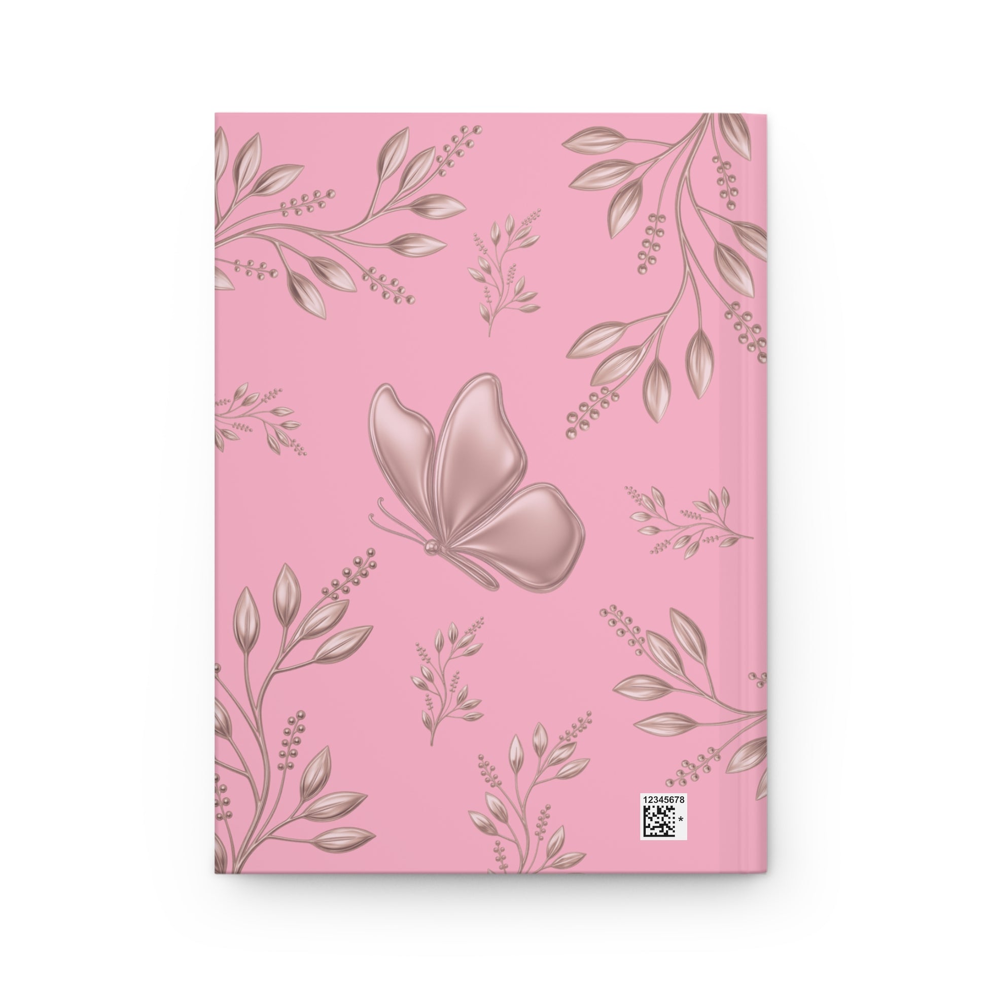 A pink notebook with a repeating pattern of metallic rose-gold leaves and a large rose-gold butterfly on the cover, shown against a plain white background.