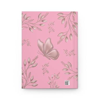 A pink notebook with a repeating pattern of metallic rose-gold leaves and a large rose-gold butterfly on the cover, shown against a plain white background.