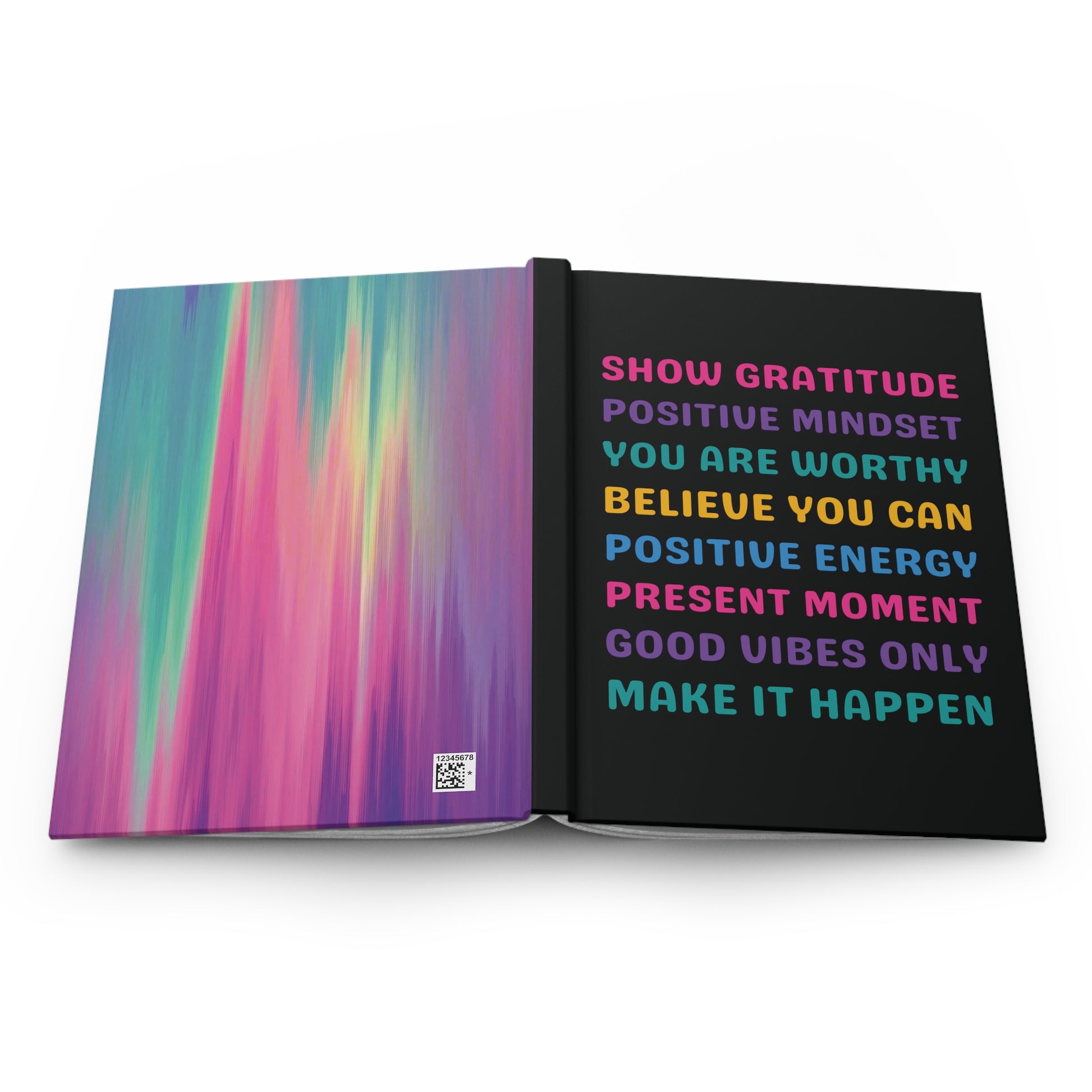 An open notebook or journal on a white background, showing a colorful abstract gradient cover on the left page and motivational text on the right page in pink, blue, yellow, and purple lettering against a black background.