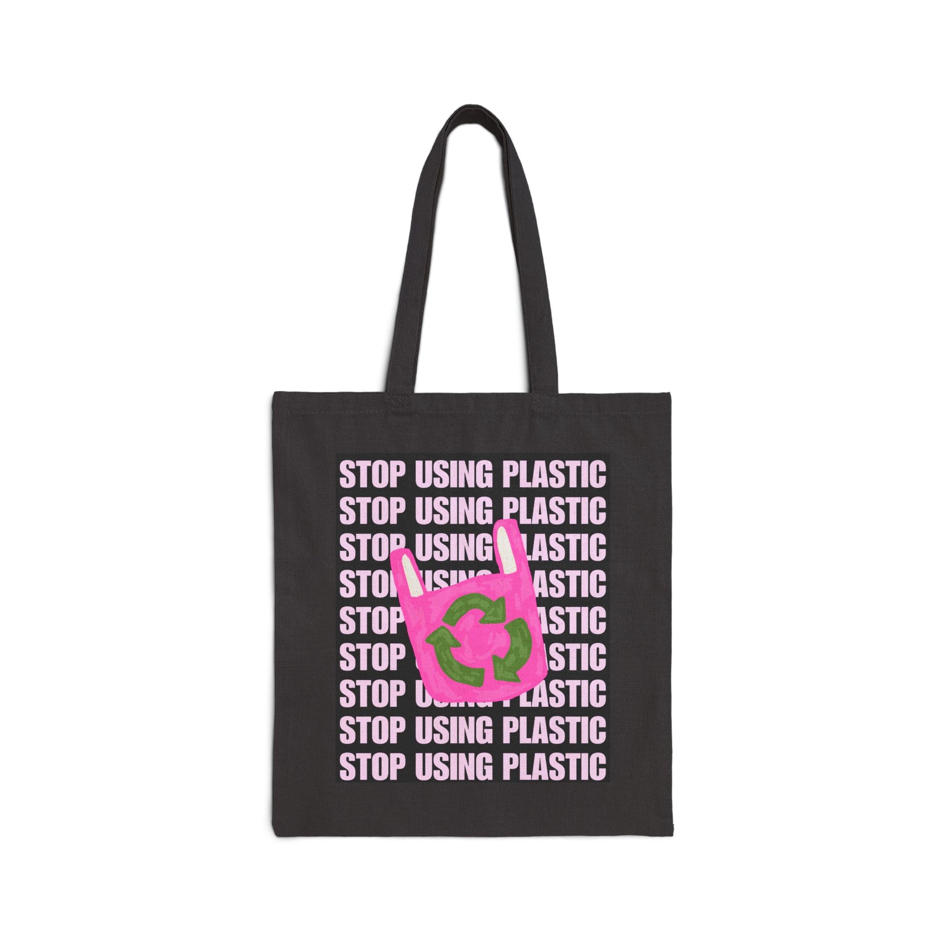 A black canvas tote bag with long black handles, featuring a graphic print of the word 'STOP' in light pink text repeated vertically, overlaid with a bright pink recycling symbol with green arrows.
