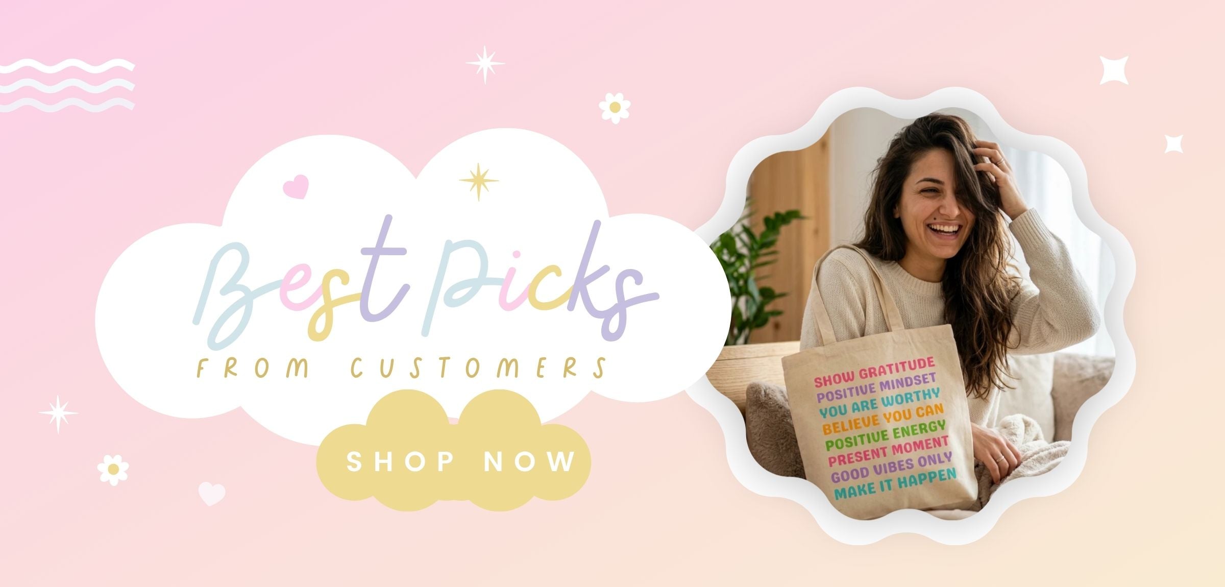 Promotional banner with a pink background, a large white cloud reading 'Best Picks FROM CUSTOMERS,' a yellow cloud reading 'SHOP NOW,' and a photo of a smiling woman holding a motivational quote book inside a scalloped frame.